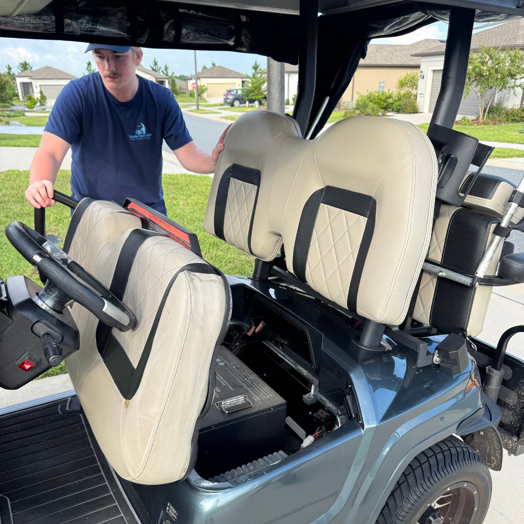 Professional technician inspecting golf cart for repairs and maintenance